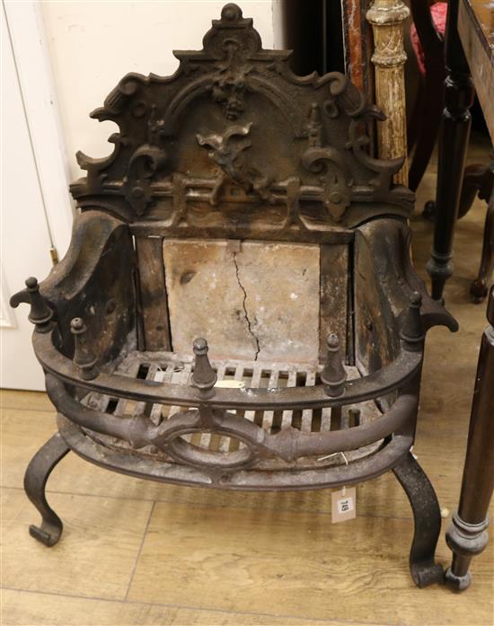 A Gothic style cast iron fire grate, the scroll back decorated with a Bagot goat jumping a fence, W.63cm